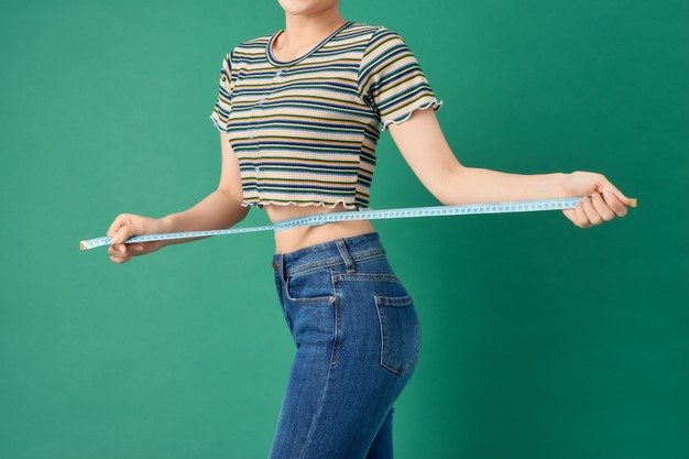 close-up-young-woman-measuring-her-waist-with-tape-measure-green_264197-3480_2.jpg